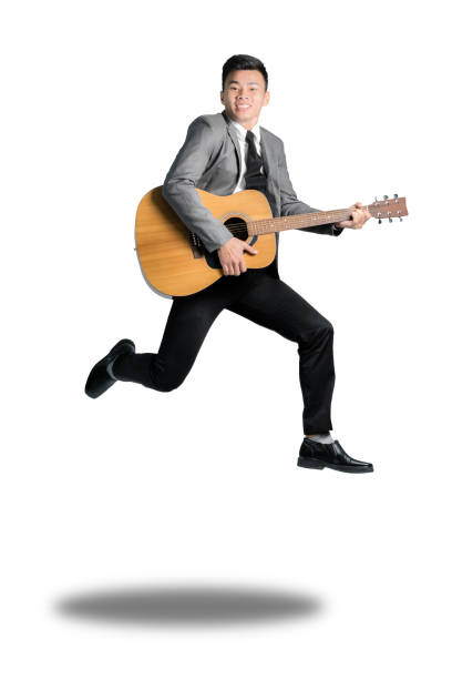 istock Young business man jumping with guitar. 638361402