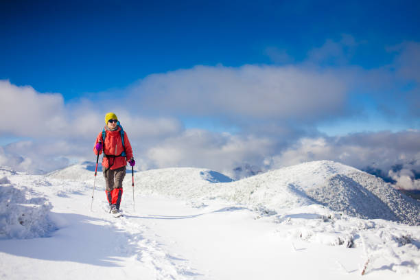 istock Girl with backpack walking on snow in the mountains. 638361448