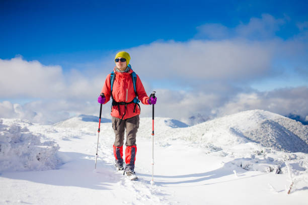 istock Girl with backpack walking on snow in the mountains. 638361960