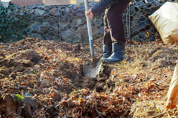 istock Man shoveling ground for landscape repair 638362126