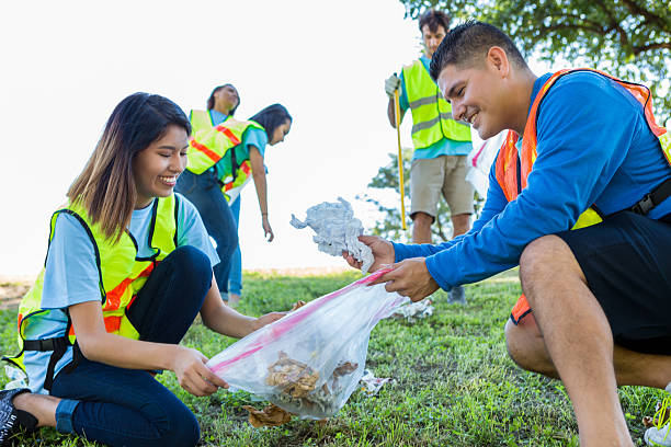istock Diverse couple help neighbors clean up community 638362466