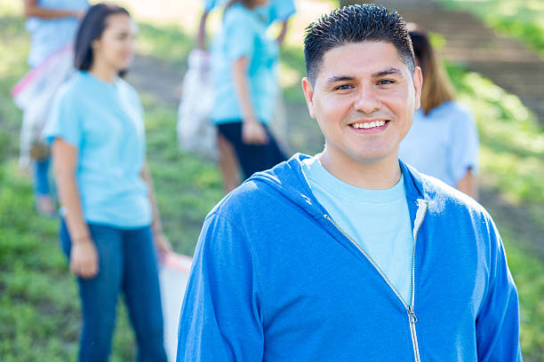 istock Handsome Hispanic male volunteer participates in community cleanup 638362518