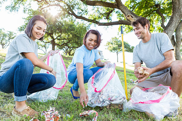 istock Diverse friends pick up garbage in community park 638362528