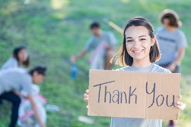 istock Smiling young woman helps with community cleanup 638362534