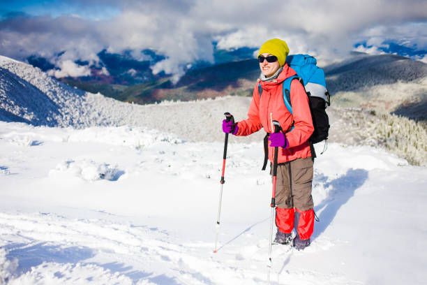 istock Girl with backpack walking on snow in the mountains. 638362614