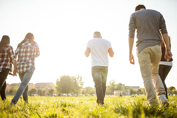 istock Group of people running on the park at dusk 638362700