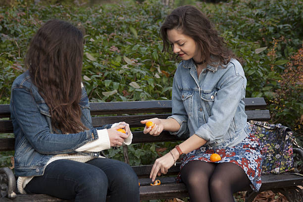 istock Girls sitting in the park 638362858