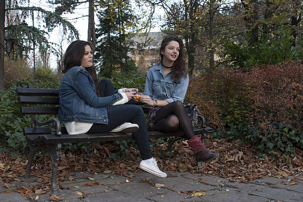 istock Girls sitting in the park 638362952