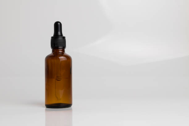 istock isolated drop glass bottle in brown color. 638364732