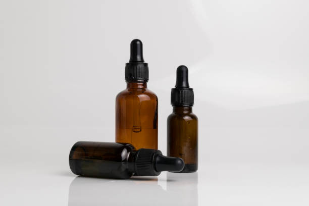 istock isolated drop glass bottle in brown color. 638364736