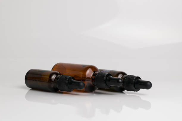 istock isolated drop glass bottle in brown color. 638364780