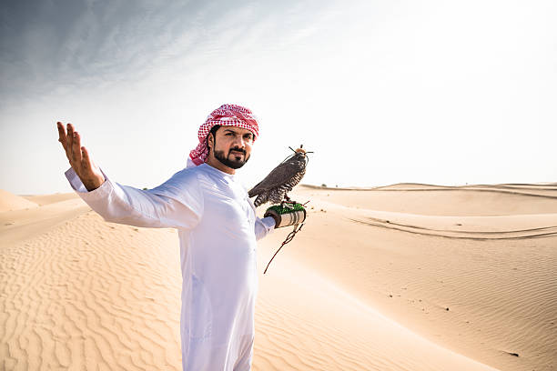 istock arabic sheik on the desert holding a falcon 638365632