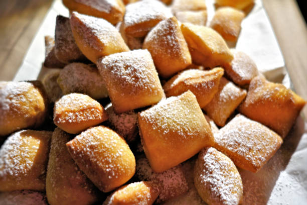 Lighty dusted fresh beignets Fresh from the oven, Lightly dusted french beignets. choux pastry photos stock pictures, royalty-free photos & images