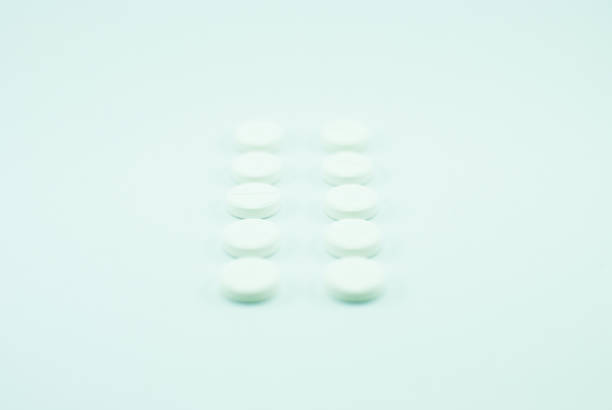 istock White pills put in the row. Isolated 638365918