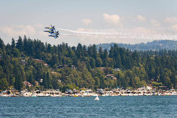 US Navy Seattle, USA - August 5, 2016: The Elite US Navy Blue Angels flying over the Seafair log boom during the airshow over Lake Union mid-day. supersonic airplane editorial airplane air vehicle stock pictures, royalty-free photos & images