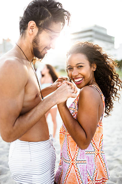 istock friends dancing on the beach for a party 638368414