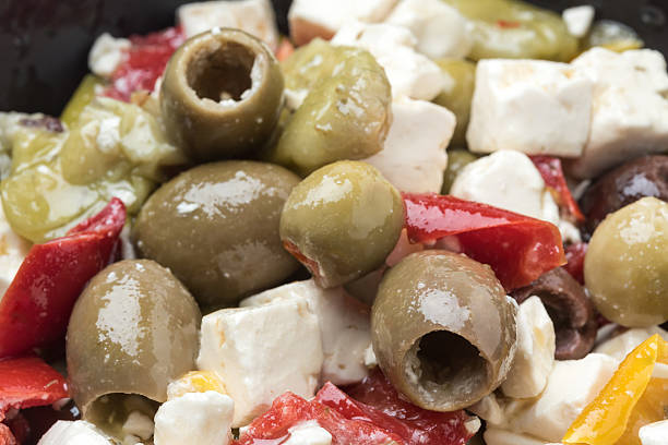Feta cheese and olives salad chunks of feta cheese with olives and spices in extra virgin olive oil dressing feta cheese block stock pictures, royalty-free photos & images
