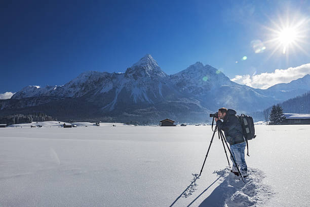 nature photographer at winter in front of mount grünstein - zugspitze mountain tirol lermoos ehrwald imagens e fotografias de stock