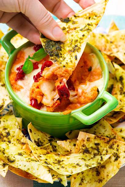 istock baked pizza dip with pesto chips 638372750