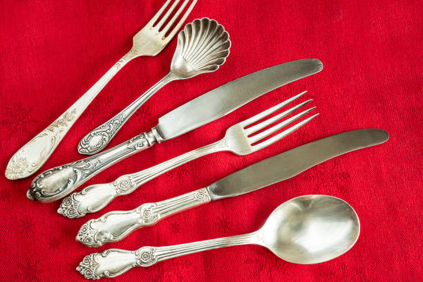 istock vintage silver cutlery on red tablecloth 638373640