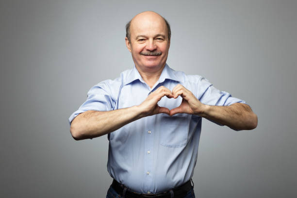 istock old man making out of hands heart. 638376434