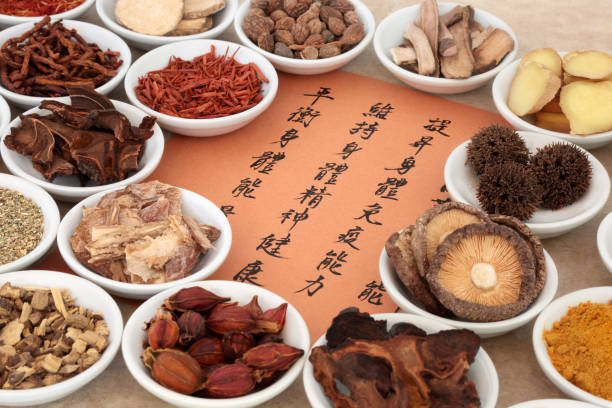 Chinese Herb Selection Traditional chinese herb selection used in herbal medicine in porcelain bowls with calligraphy script. Translation describes the medicinal functions to maintain body and spirit health and balance energy. tribulus terrestris stock pictures, royalty-free photos & images
