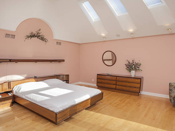 istock Stunning spacious bedroom with skylights, hardwood floor 638379304