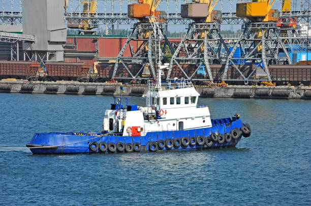 istock Tugboat and port cargo crane 638379732