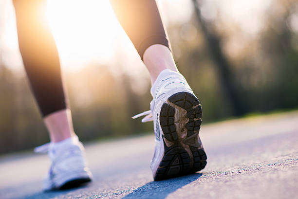 istock Female Runner feet sunrise walking outside 638379820