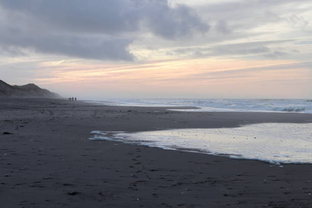 istock Peple walking on the beach at sunset. 638380514