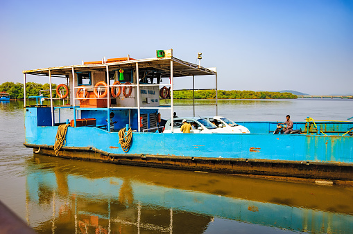 Goa, India - November 13, 2012: Ferry arriving to Chorao island, Salim Ali Bird Sanctuary, Goa, India. Ferries is the only means of transport across the many rivers of India, as there is no bridge