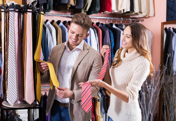 istock Couple choosing tie in store 638383250