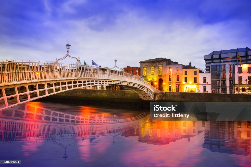 Dublin Ha'penny Bridge of the River Liffey in Dublin Ireland in the evening with lights and reflections Dublin - Republic of Ireland Stock Photo