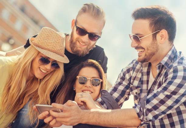istock Group of four happy friends taking selfie 638384102