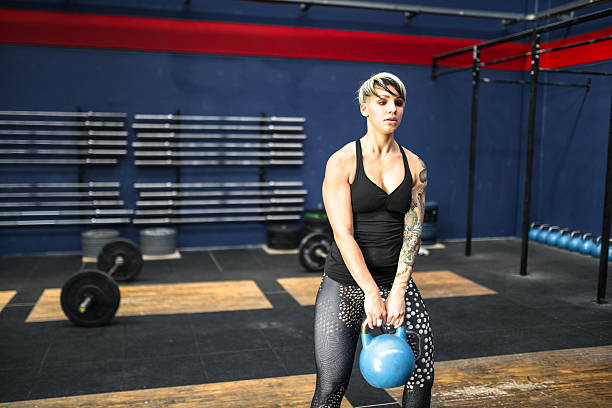 woman using the kettlebell on the gym