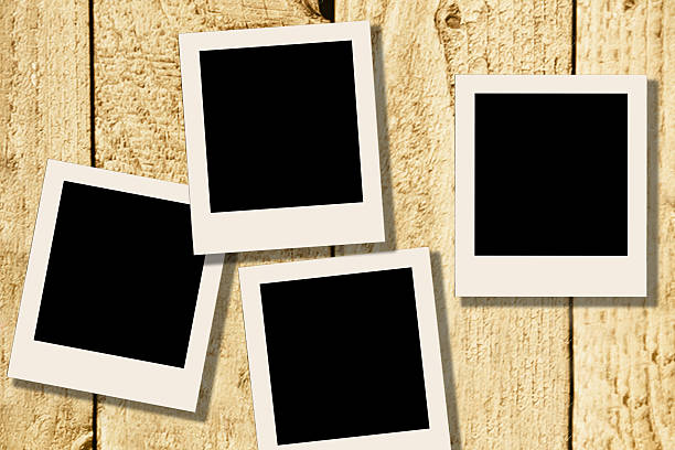 istock Blank, polaroid-style photographs on rustic wooden table. 638386342