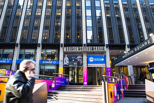 New York City, New York, USA - January 6, 2017:  Exterior street view of Madison Square Garden in midtown Manhattan NYC with people visible.  Madison Square Garden is a world famous sports arena and concert venue.