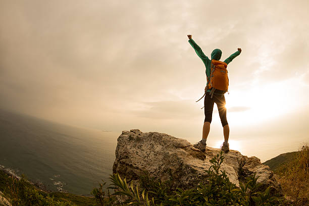istock successful hiker hiking on seaside mountain peak 638390292