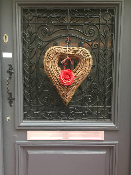 istock Red roses heart shape wreath on gray door 638392702
