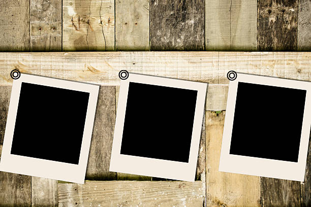 istock Blank, polaroid-style photographs on rustic wooden table. 638396818
