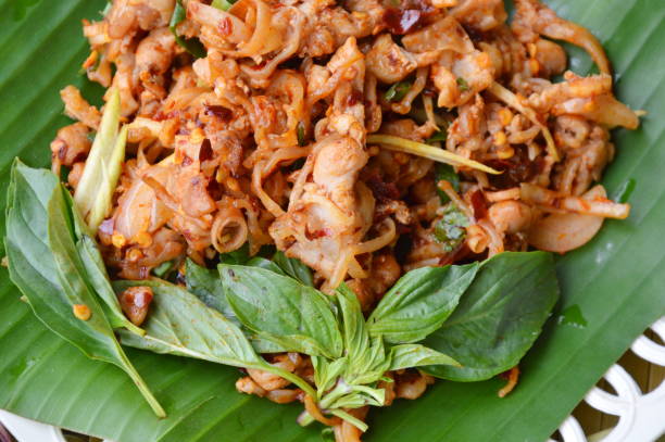 istock spicy chicken tendon salad on banana leaf 638396856
