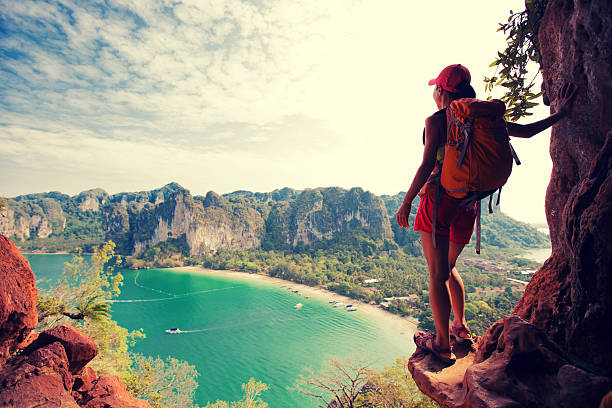 istock young woman backpacker hiking on seaside mountain 638399214