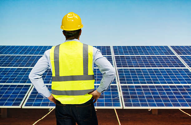 istock Rear view of solar worker standing outdoors 638399564