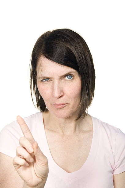 Mature woman making scolding expression on white background