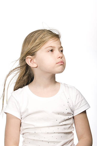 istock Young girl looking sideways on white background 638400542