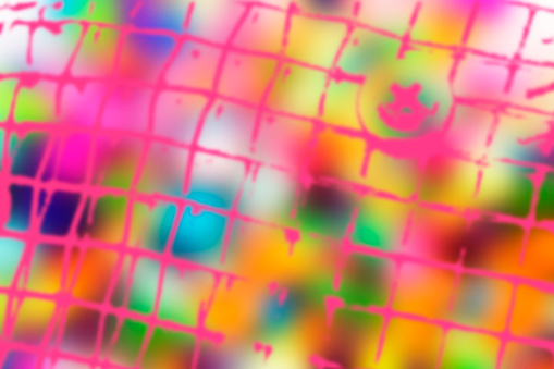 Abstract, brightly colored background in various hues with pink overlay.