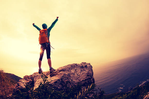 istock successful hiker hiking on seaside mountain peak 638404106