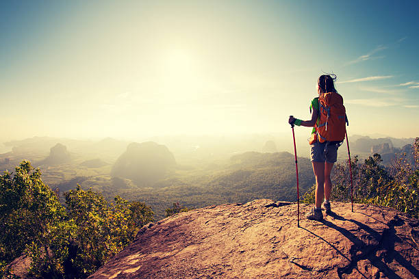 istock successful hiker hiking on sunrise mountain peak 638404490
