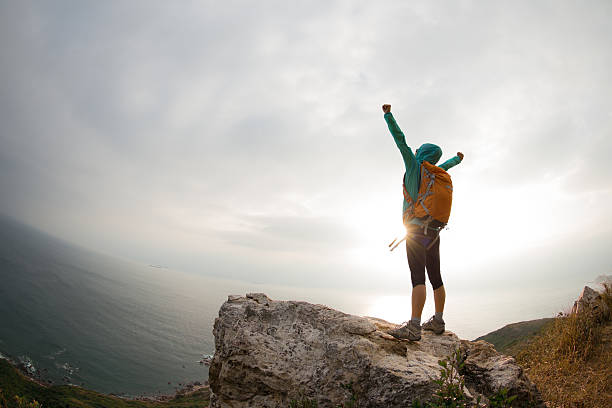 istock successful hiker hiking on seaside mountain peak 638405310