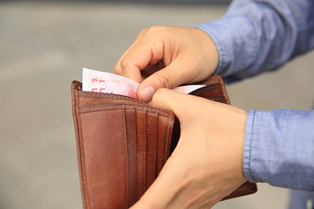 istock Hands taking  money  out from wallet on the street 638407180